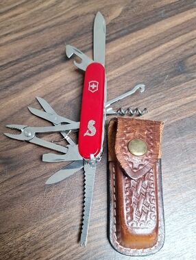 Victorinox Red Swiss Army Multi-Tool with Leather Pouch. Has fishing logo.